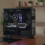 Open pc met videokaart op een houten bureau